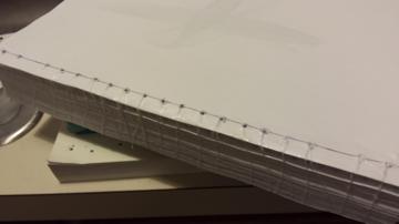 String is really all you need for the spine, but glue is extra security