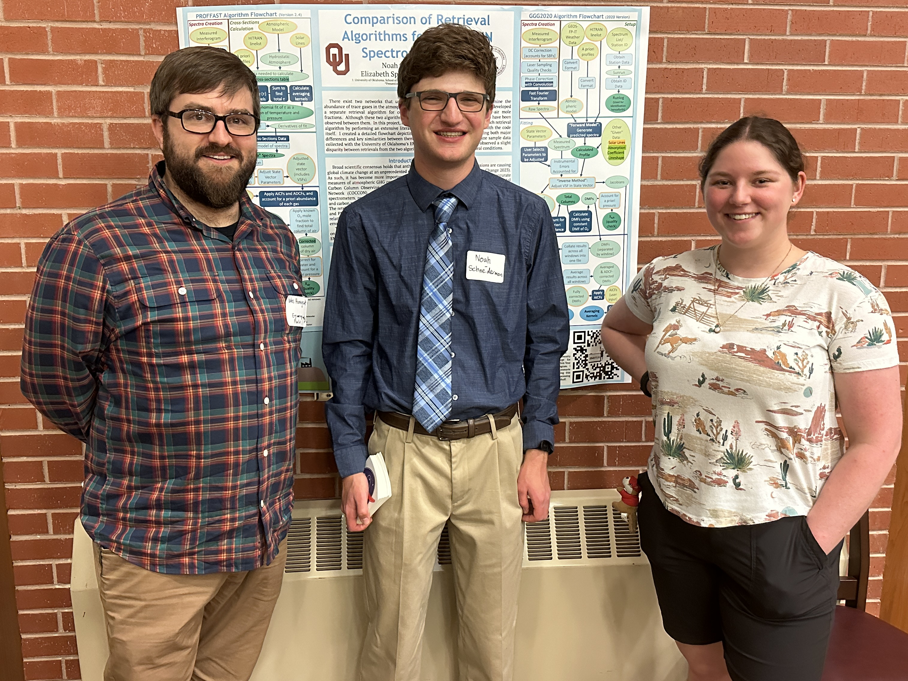 Wes, Noah Schneiderman, and Elizabeth Spicer standing in front of his poster.